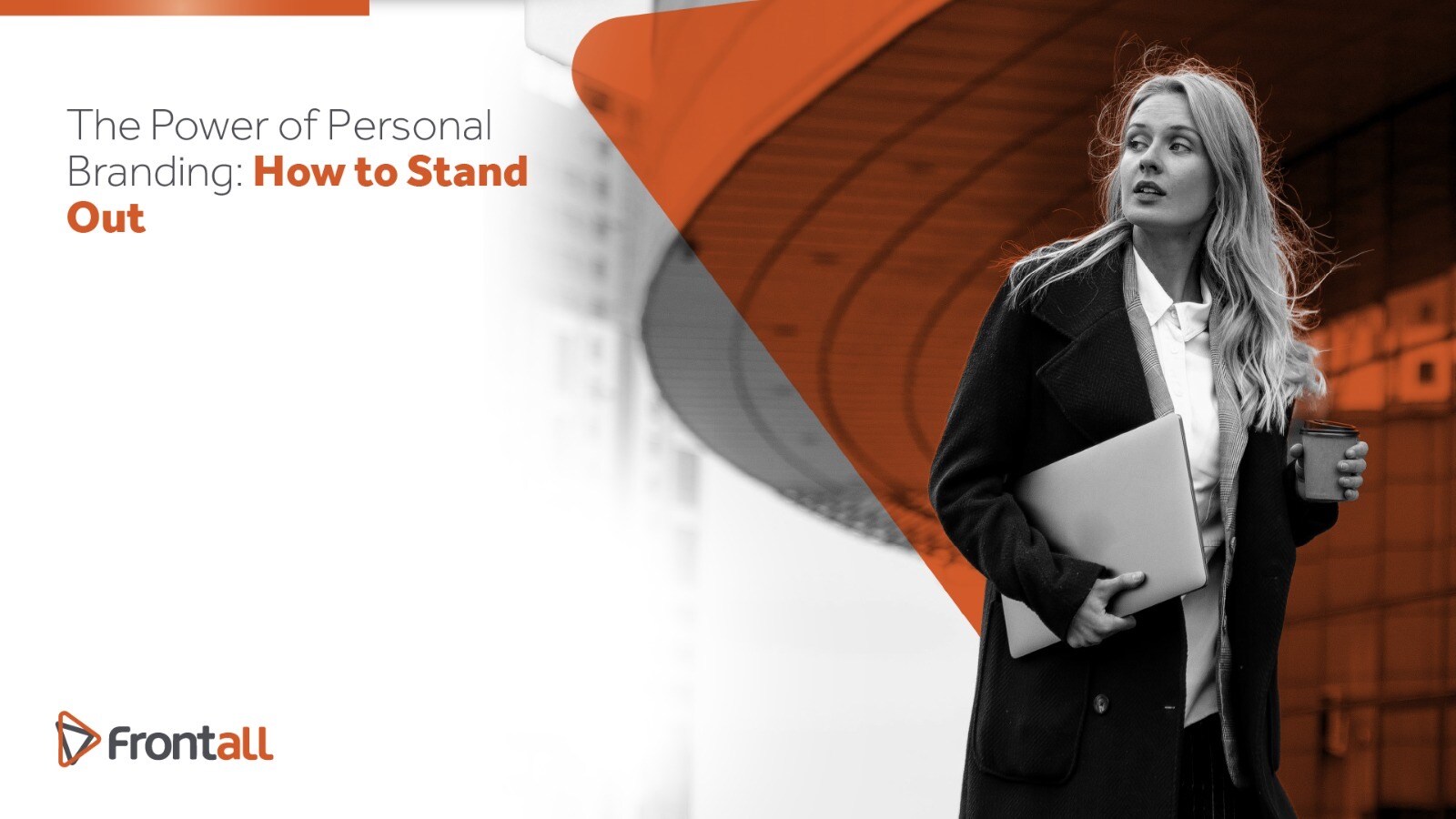 business woman holding a cup of coffee and a computer while she is walking
